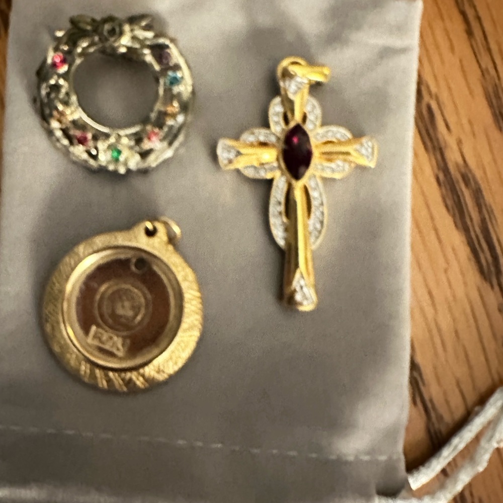Gemstones, cross has real ruby $65,  diamond pendant $80. All others are $8 each